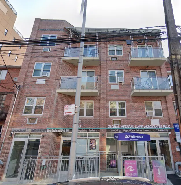 Google Maps Street View screenshot of 40-23 74th Street, showing a red-brick facade, projecting balconies and ground-floor storefronts.